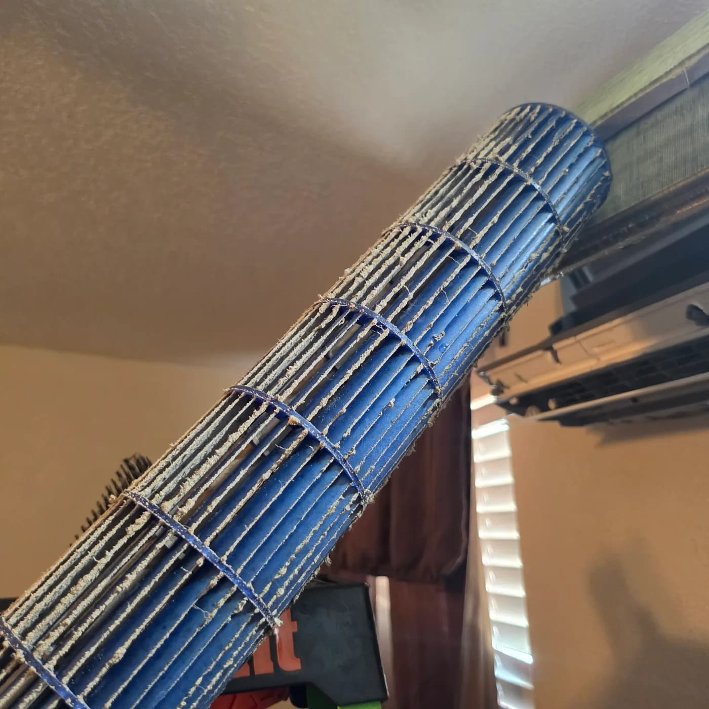 Dirty ductless mini split blower wheel caked with dust and grime before cleaning in Vail, AZ