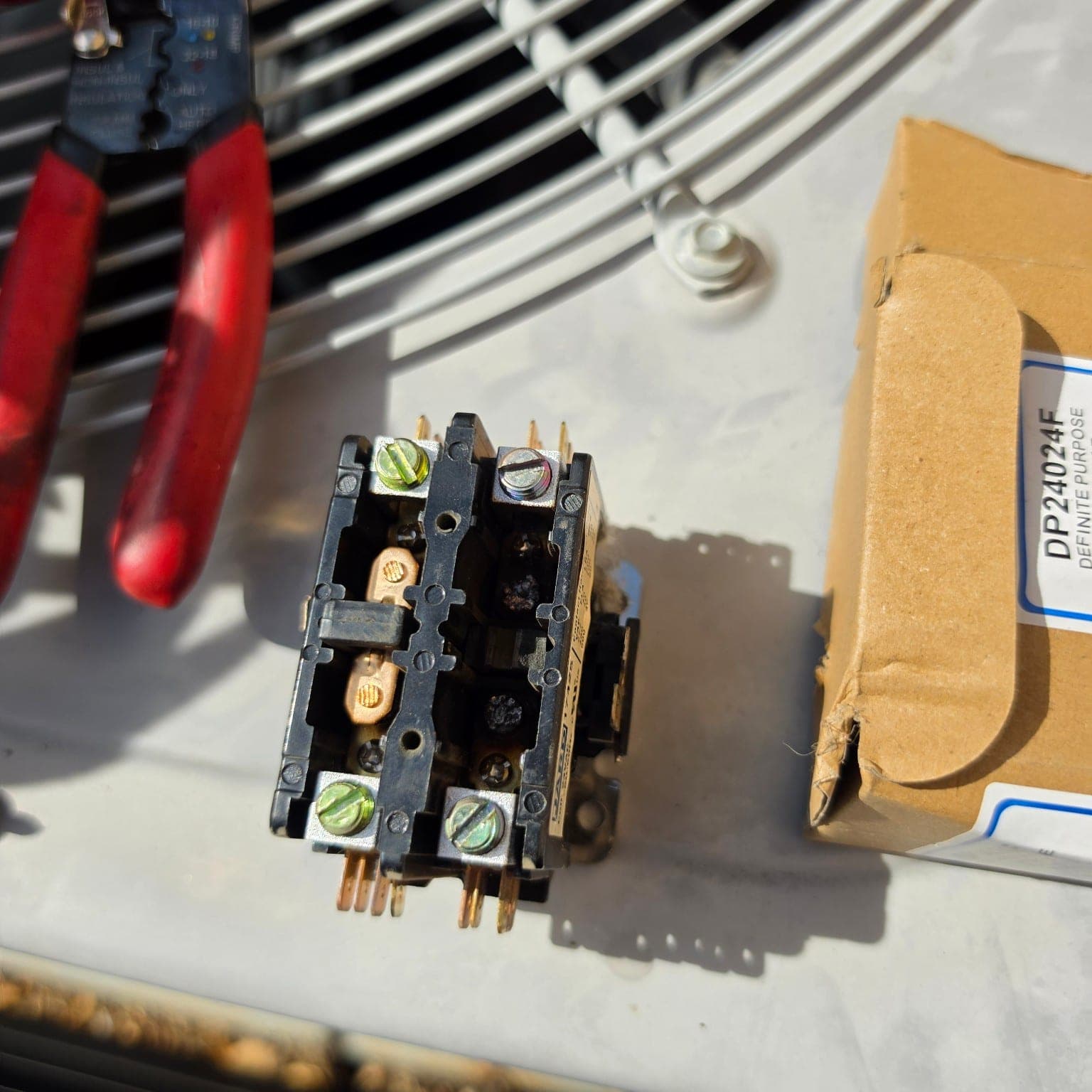 Burned AC contactor contacts found during HVAC maintenance inspection