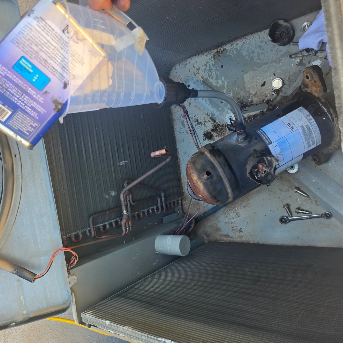 R-22 to R-407C retrofit: measuring and pouring new POE synthetic oil into the compressor
