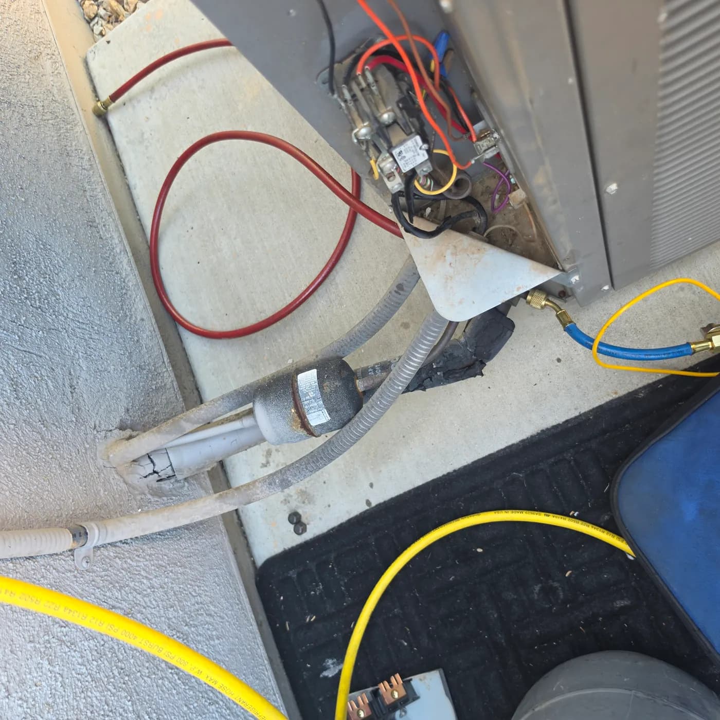 R-22 to R-407C retrofit: the original R-22 liquid-line filter drier still installed in the copper lineset before removal