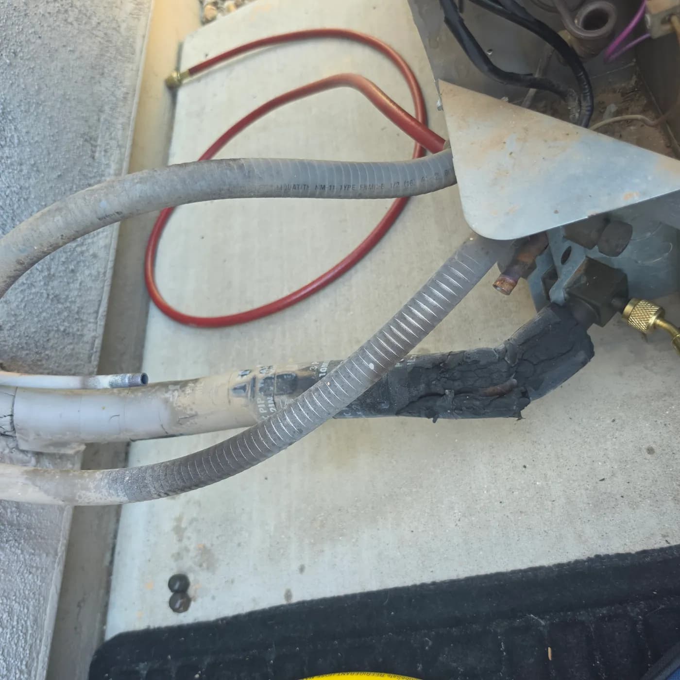 R-22 to R-407C retrofit: removing the old liquid-line filter drier at the condenser to install a new POE-rated drier