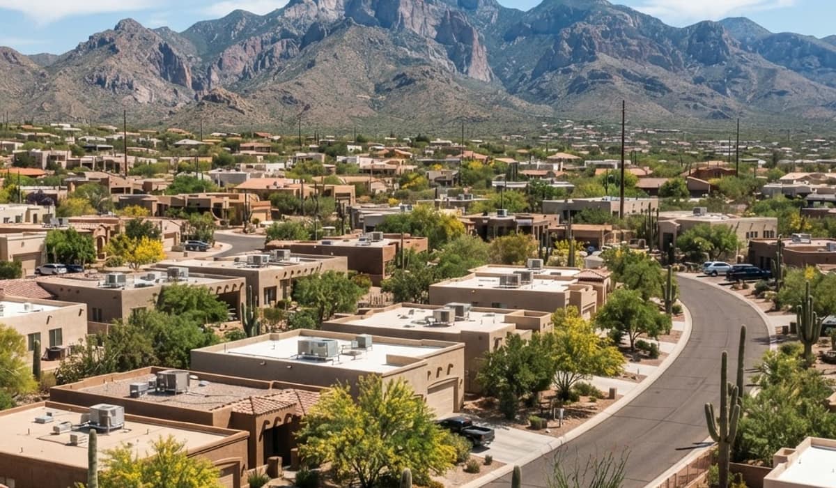 Tucson, Arizona residential rooftops with saguaro cactus and mountains in the summer heat