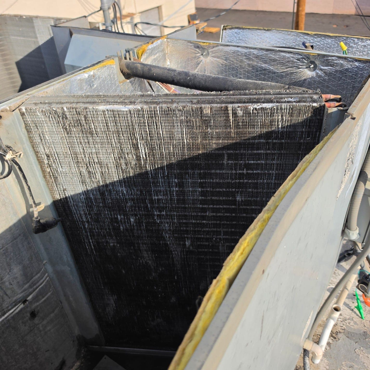 Severely dirty evaporator coil restricting airflow before HVAC maintenance