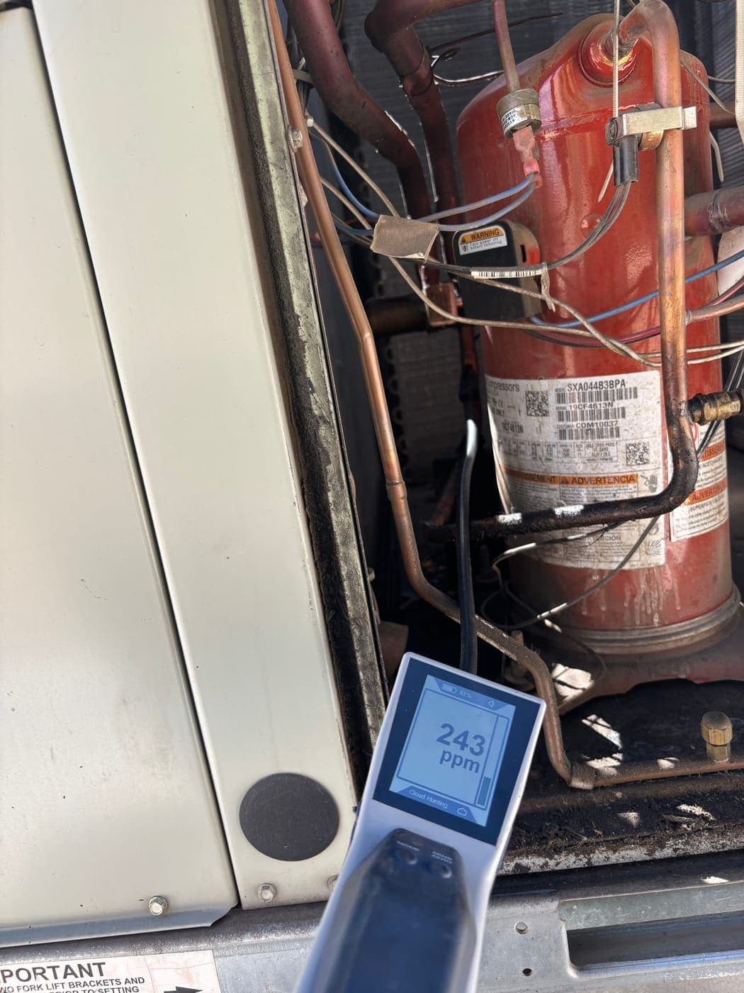 Major refrigerant leak detected on Trane compressor showing 243 PPM reading